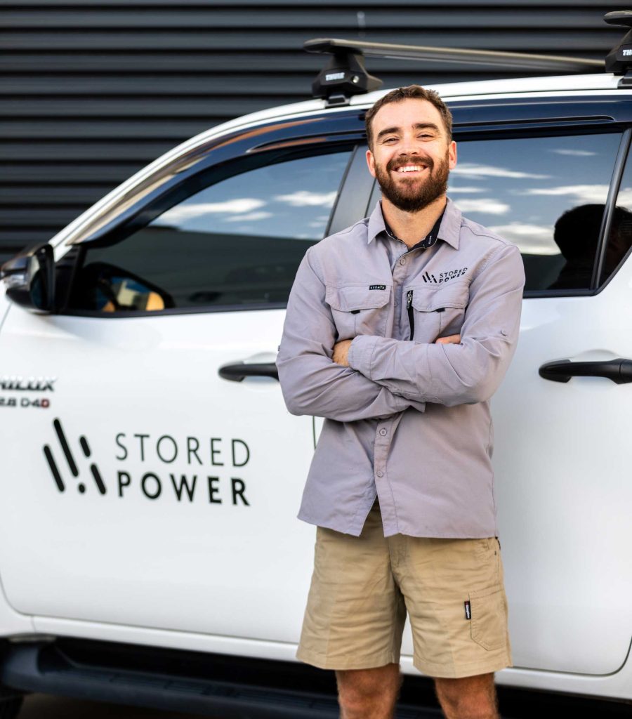 Stored Power solar installer standing in front of branded vehicle on the Gold Coast